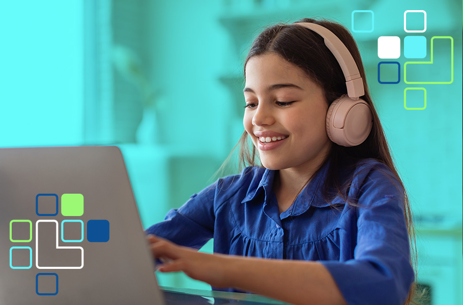 A girl working on a laptop wearing headphones