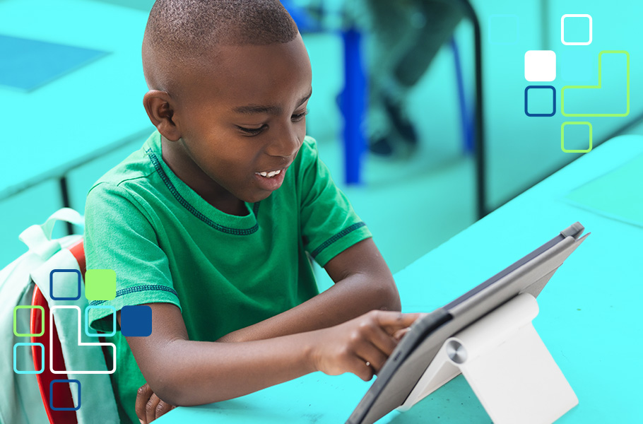 A child sitting at a desk with a tablet